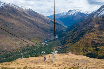View of the mountain gorge with a single-seat cable car line for tourists, skiers and climbers. 