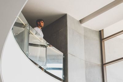 Young man leaning on railing