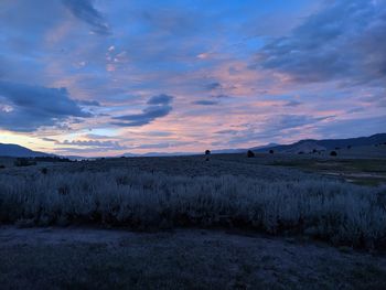 Scenic view of land against sky during sunset