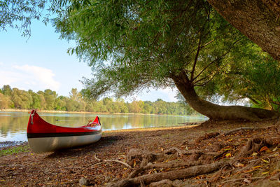 Boat moored on beach against sky