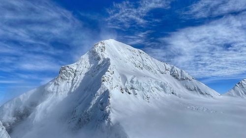 Scenic view of snowcapped mountain against sky