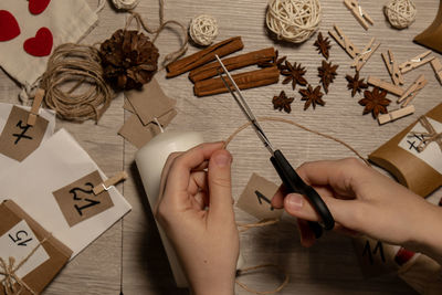 Cropped hands of woman holding toy blocks on table