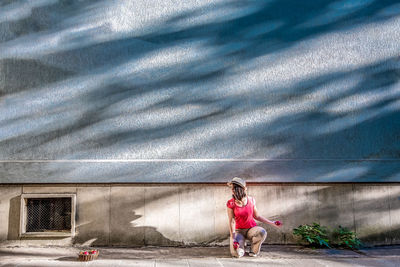 Full length of woman with shadow on wall