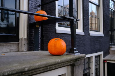 View of orange pumpkins against building