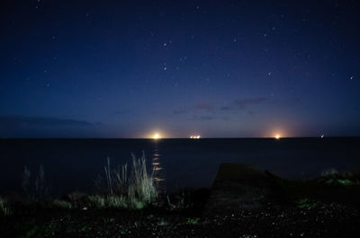 Scenic view of sea against sky at night