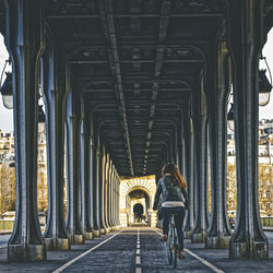 Rear view of woman on bridge