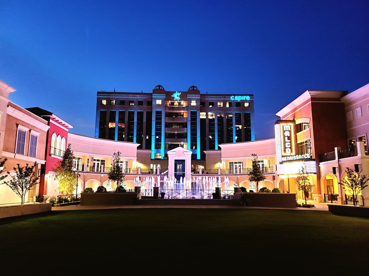 ILLUMINATED BUILDINGS AGAINST CLEAR BLUE SKY