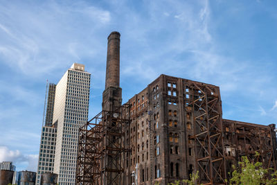 Low angle view of modern buildings against sky in city