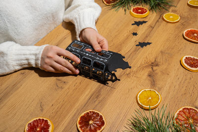 Midsection of man holding food on table