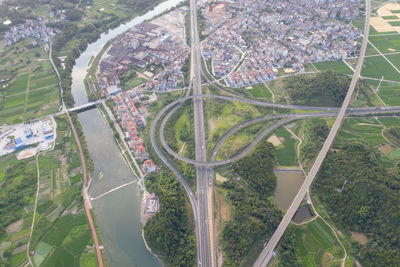 High angle view of highway amidst trees in city