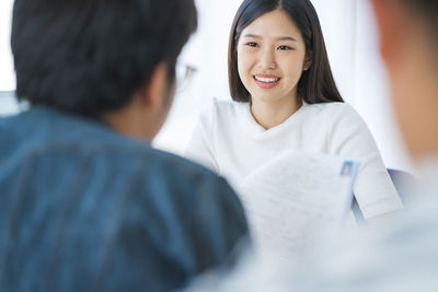 Manager taking interview of young woman at office