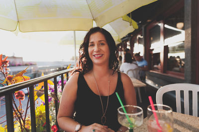 Portrait of smiling young woman standing outdoors