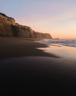 Scenic view of sea against clear sky during sunset