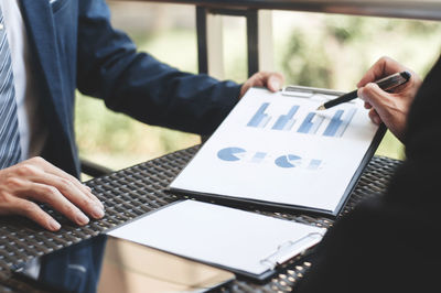 Close-up of business colleagues working in office