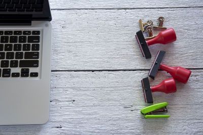 Directly above shot of office supplies with laptop on table