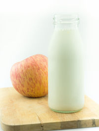 Close-up of drink on table against white background