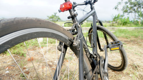 Close-up of bicycle parked on field