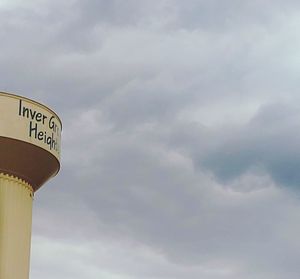 Low angle view of sign against sky