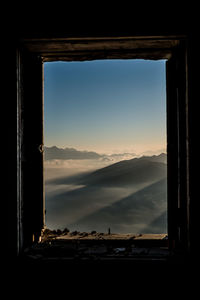 Scenic view of mountains seen through window