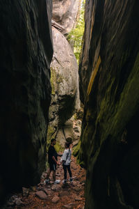 Rear view of man standing on rock formation