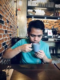 Man drinking coffee in restaurant