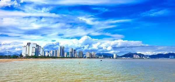 Panoramic view of sea and buildings against sky