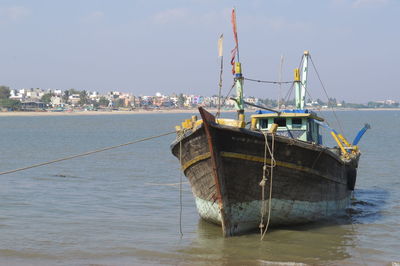 Fishing boat in sea against sky