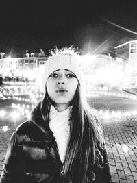 Portrait of woman standing in city during winter