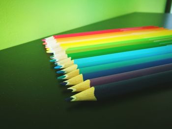 Close-up of colorful colored pencils on table