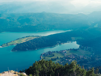 Scenic view of sea and mountains against sky