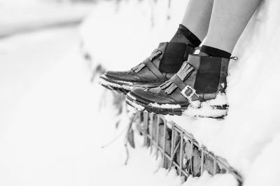 Low section of woman standing on snow