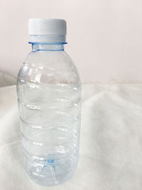 Close-up of water in glass bottle on table