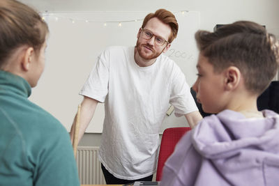 Teacher talking with children in classroom