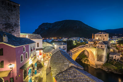 High angle view of illuminated buildings in city at night