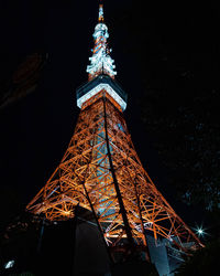 Low angle view of illuminated building against sky at night