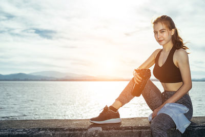 Portrait of woman smiling against sky