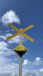 Low angle view of road sign against sky