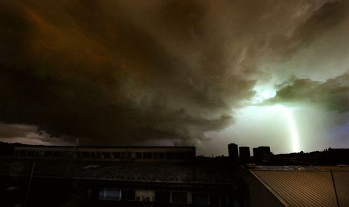 Storm clouds over buildings in city