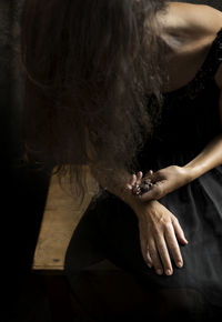 Woman in black dress with dried flowers in her hand