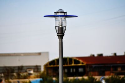 Close-up of street light against building