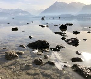 Scenic view of sea and mountains against sky