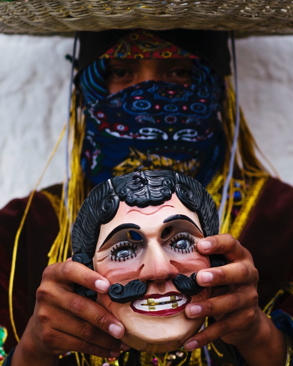 headshot, front view, close-up, focus on foreground, mask - disguise, person, looking at camera, human face, day, young adult, creativity, facial expression