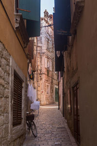 Narrow alley amidst buildings in city