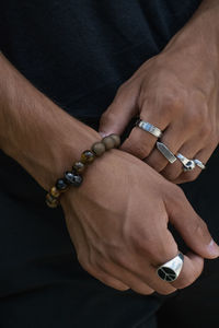 Close-up of wearing bracelet and rings