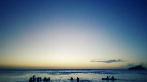 Scenic view of sea against clear sky during sunset