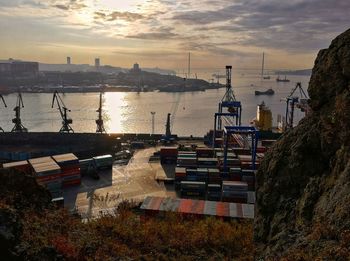 High angle view of sailboats moored at harbor during sunset