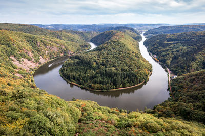 Scenic view of river amidst mountains against sky