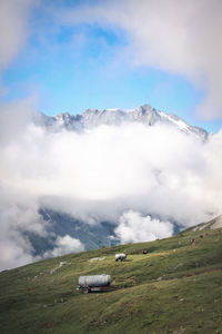 Scenic view of land and mountains against sky