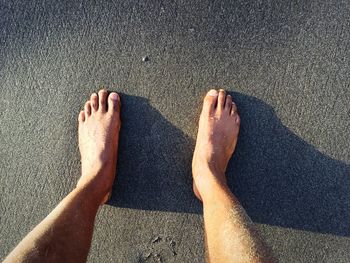 Low section of people on sand at beach