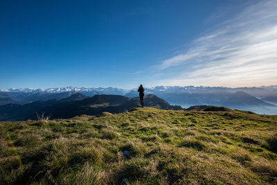 Man standing on mountain against sky